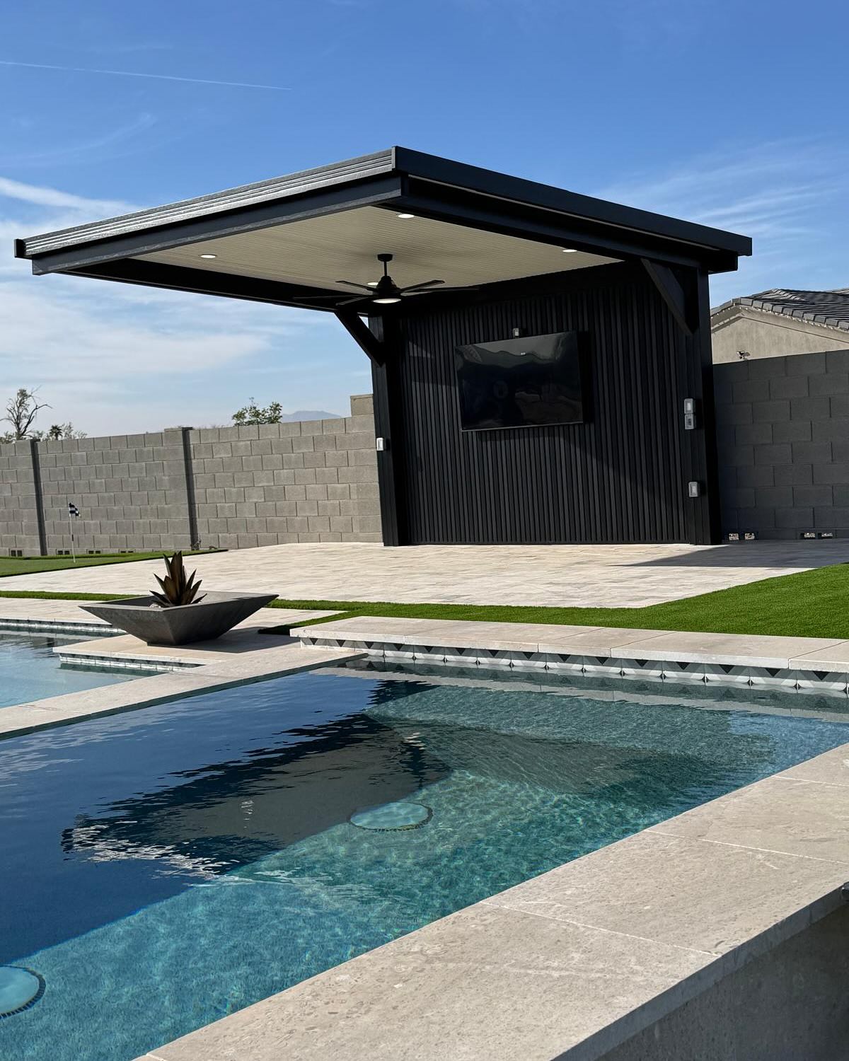 White solid top patio cover with palm trees and pool